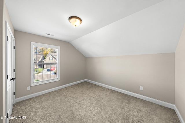 bonus room with carpet flooring and vaulted ceiling