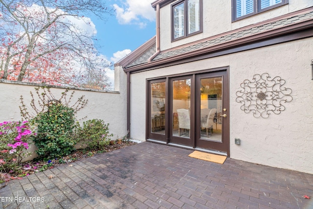 view of exterior entry featuring a patio