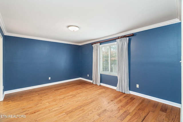 unfurnished room with crown molding and hardwood / wood-style floors