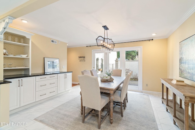 dining area featuring ornamental molding and an inviting chandelier