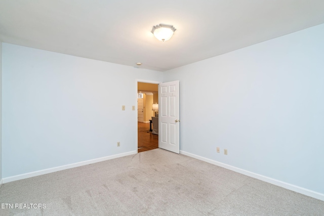 unfurnished room with light carpet