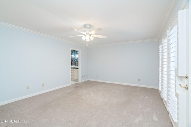 carpeted empty room featuring ceiling fan and ornamental molding