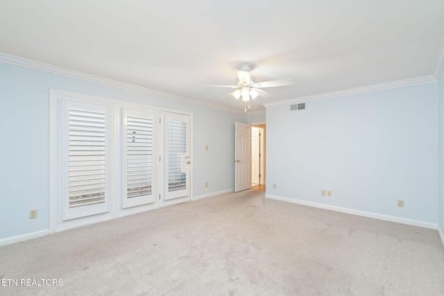 empty room with ceiling fan, light colored carpet, and crown molding