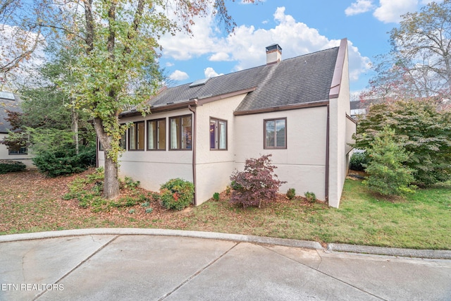 view of property exterior featuring a lawn