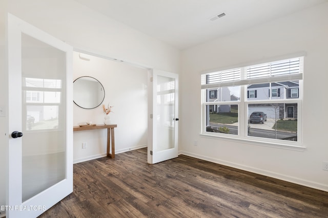 interior space featuring french doors and dark hardwood / wood-style floors