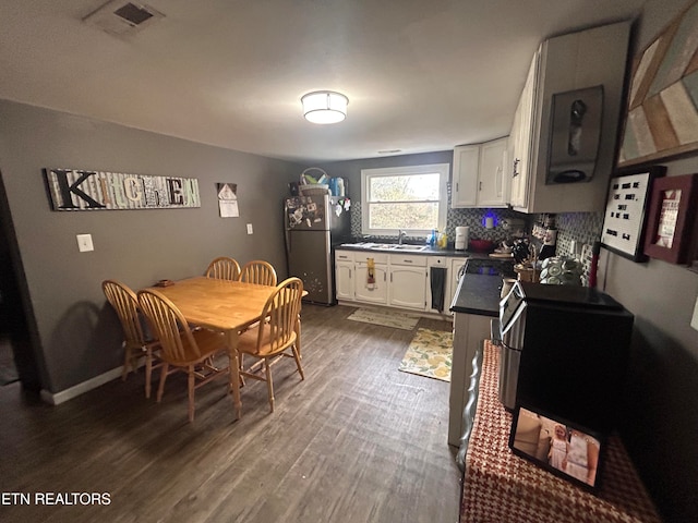 dining area featuring dark hardwood / wood-style flooring and sink