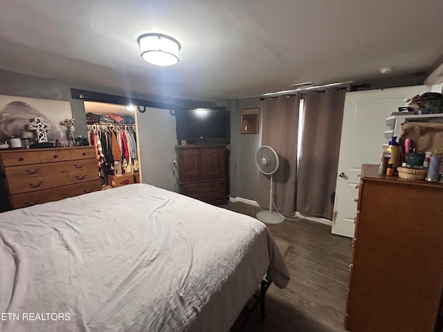 bedroom featuring a closet and dark hardwood / wood-style floors