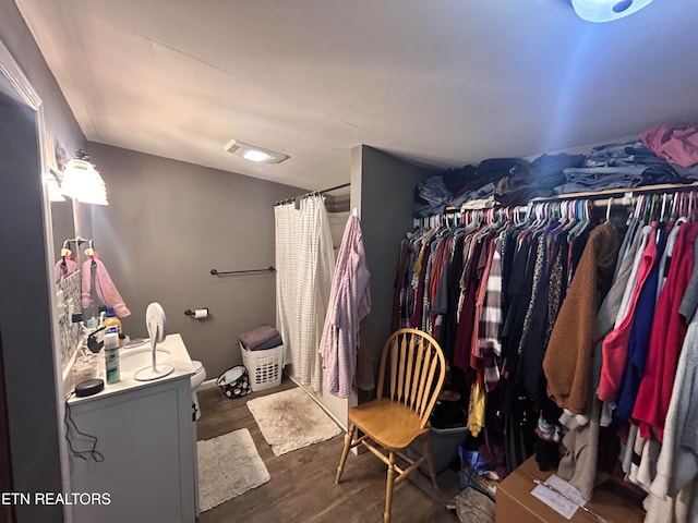 spacious closet featuring dark wood-type flooring