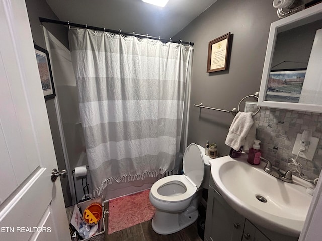 full bathroom featuring shower / tub combo, tasteful backsplash, vanity, wood-type flooring, and toilet