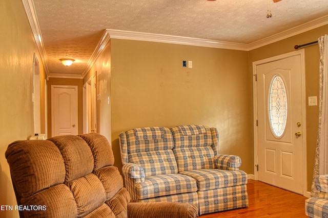 foyer featuring hardwood / wood-style flooring, crown molding, and a textured ceiling