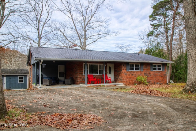 ranch-style home featuring a storage unit