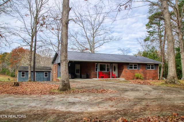 ranch-style home featuring an outbuilding