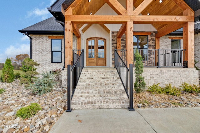 doorway to property featuring covered porch and french doors