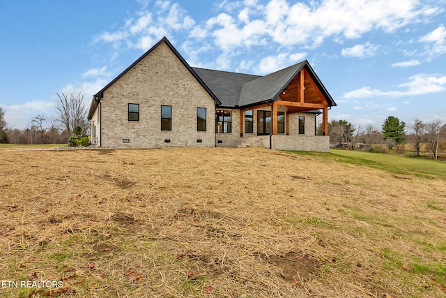 rear view of property with a yard