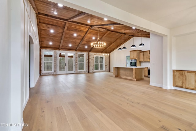 unfurnished living room featuring light hardwood / wood-style flooring, beamed ceiling, wood ceiling, and a notable chandelier