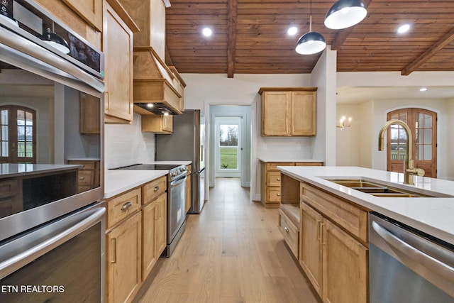 kitchen with sink, stainless steel appliances, light hardwood / wood-style floors, decorative light fixtures, and wood ceiling