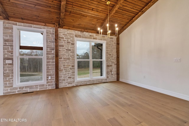 unfurnished room with plenty of natural light, an inviting chandelier, wood ceiling, and light hardwood / wood-style flooring