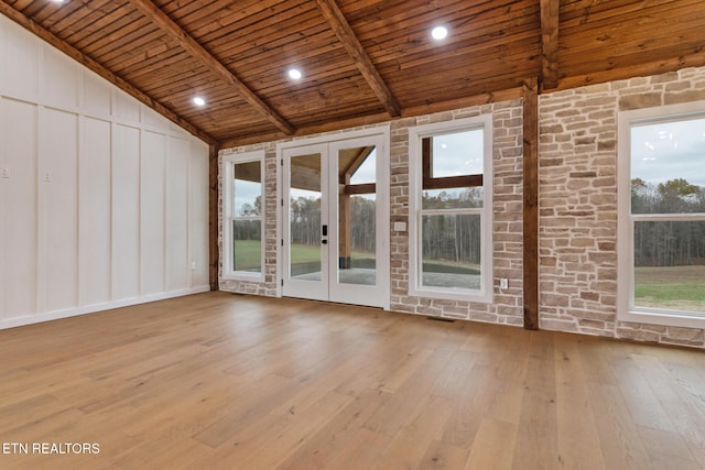 empty room with light hardwood / wood-style floors and a healthy amount of sunlight