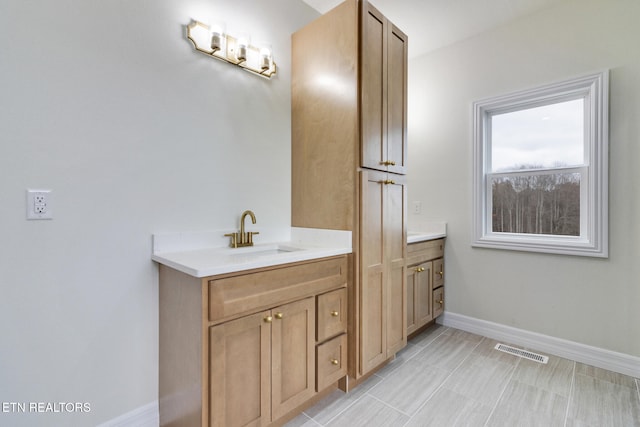 bathroom with tile patterned flooring and vanity