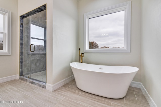 bathroom with shower with separate bathtub