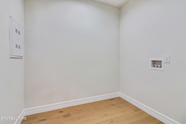 washroom with hookup for a washing machine and hardwood / wood-style flooring