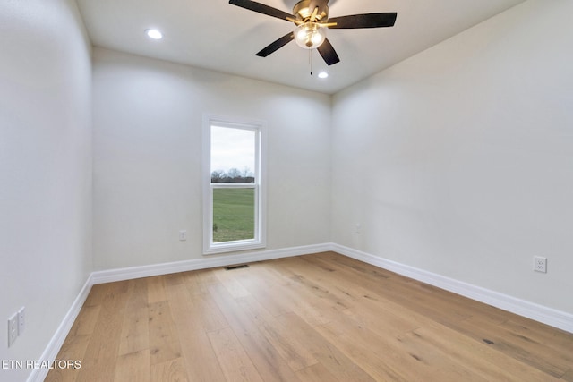 spare room with light hardwood / wood-style flooring and ceiling fan