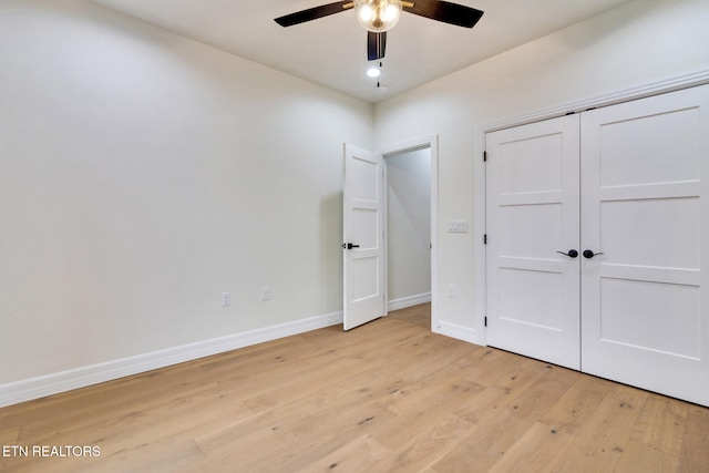 unfurnished bedroom featuring light wood-type flooring, a closet, and ceiling fan