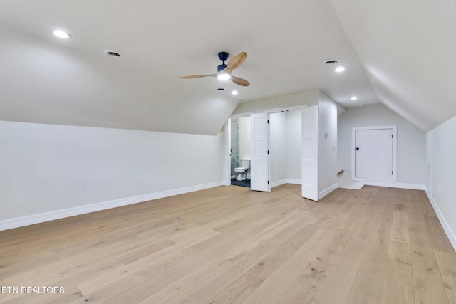 additional living space featuring ceiling fan, light wood-type flooring, and vaulted ceiling