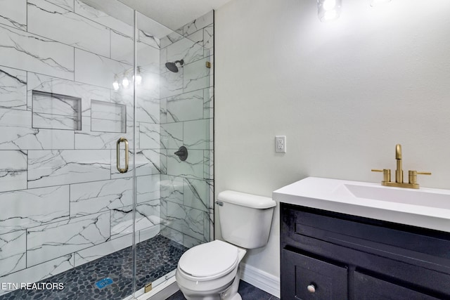 bathroom with vanity, toilet, and an enclosed shower