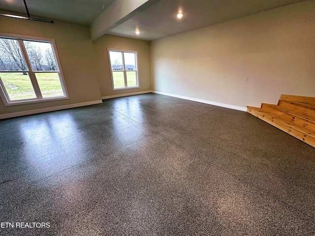 spare room featuring beamed ceiling