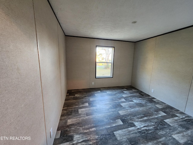 unfurnished room featuring a textured ceiling