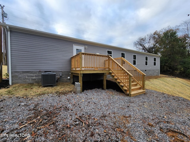 back of house featuring central AC and a deck