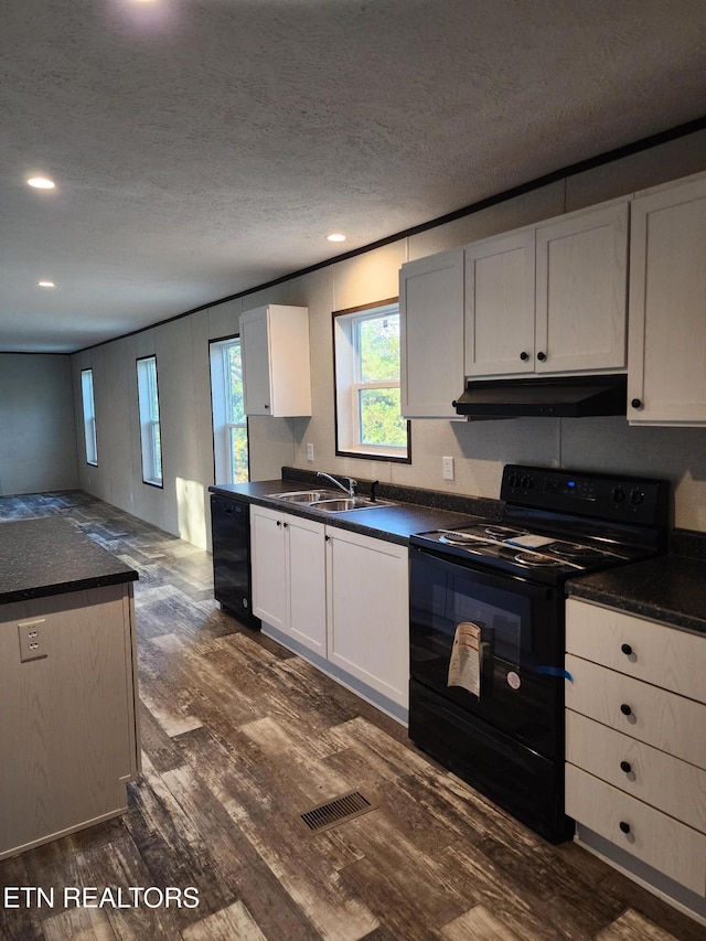 kitchen featuring white cabinetry, sink, dark hardwood / wood-style floors, a textured ceiling, and black appliances