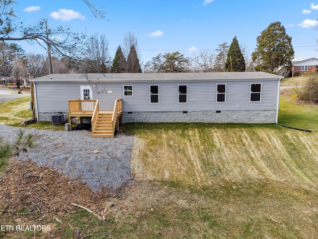 back of house featuring a deck, central AC unit, and a lawn