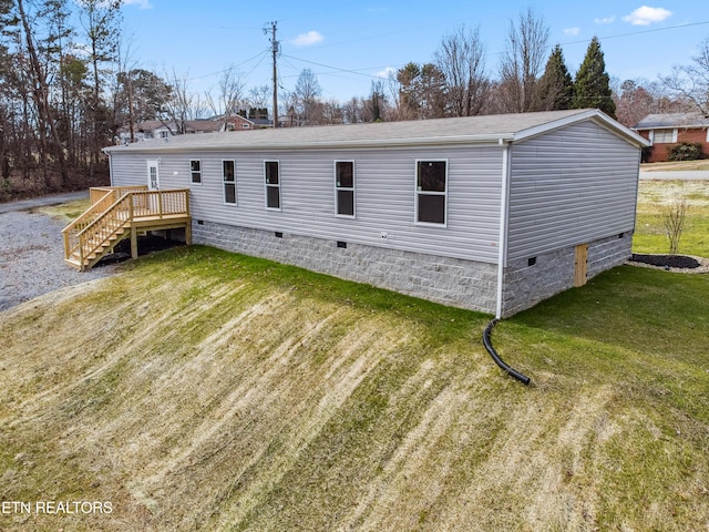 back of property with a yard and a deck