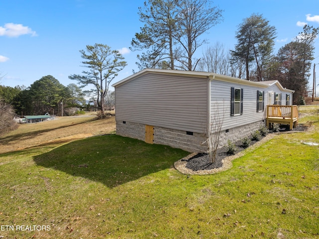 view of home's exterior featuring a yard and a wooden deck