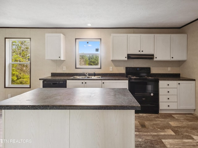 kitchen with sink, white cabinetry, a kitchen island, crown molding, and black appliances