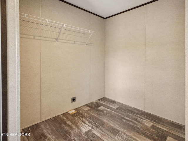 interior space featuring hookup for an electric dryer, crown molding, and hardwood / wood-style floors