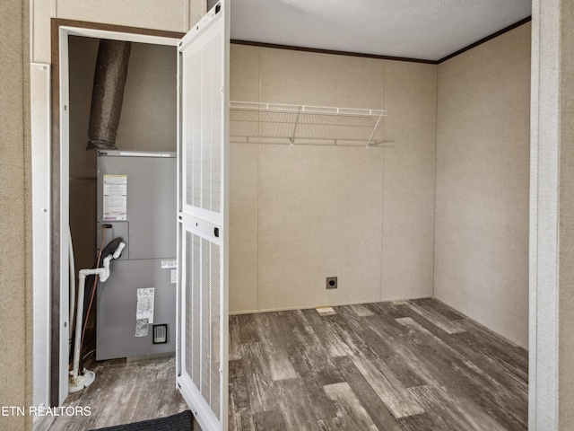 washroom with ornamental molding and wood-type flooring