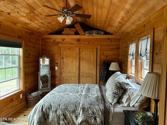 bedroom featuring multiple windows, ceiling fan, lofted ceiling, and hardwood / wood-style flooring