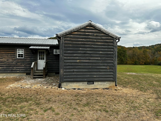 view of outbuilding featuring a yard