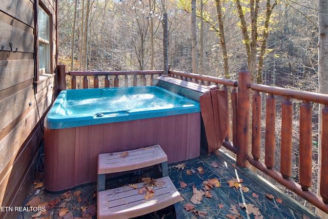 wooden terrace featuring a hot tub