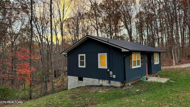 view of property exterior featuring a yard and an outdoor structure