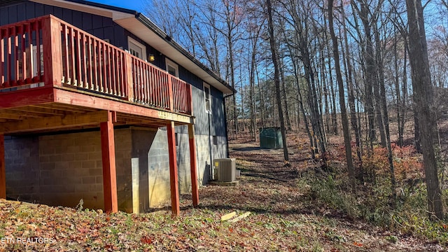 view of side of property featuring central AC unit and a deck