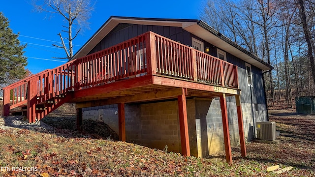 rear view of house with central air condition unit and a wooden deck