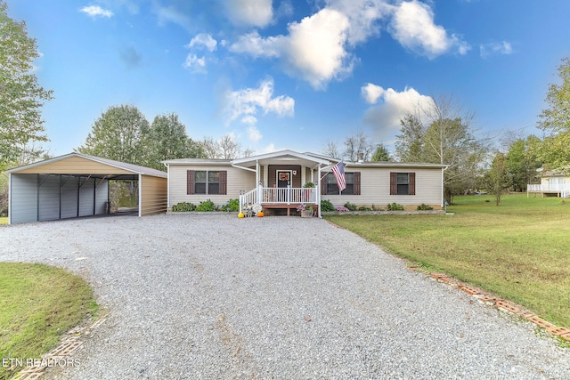 view of front facade featuring a carport, covered porch, and a front yard