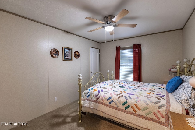 bedroom with a textured ceiling, carpet floors, and ceiling fan