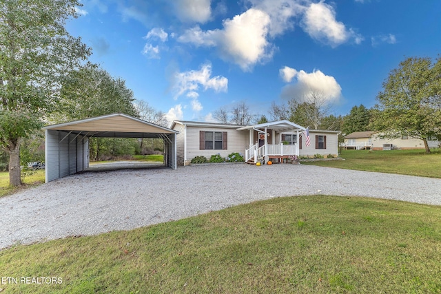 ranch-style home with covered porch, a front yard, and a carport