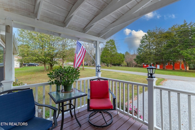 deck with a lawn and covered porch