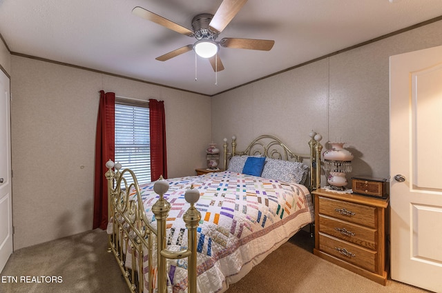 carpeted bedroom featuring ceiling fan and crown molding